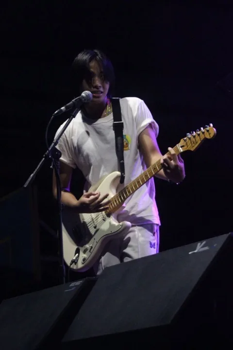 Kiki, owner of Dragon Dance Collectibles, on stage with his band